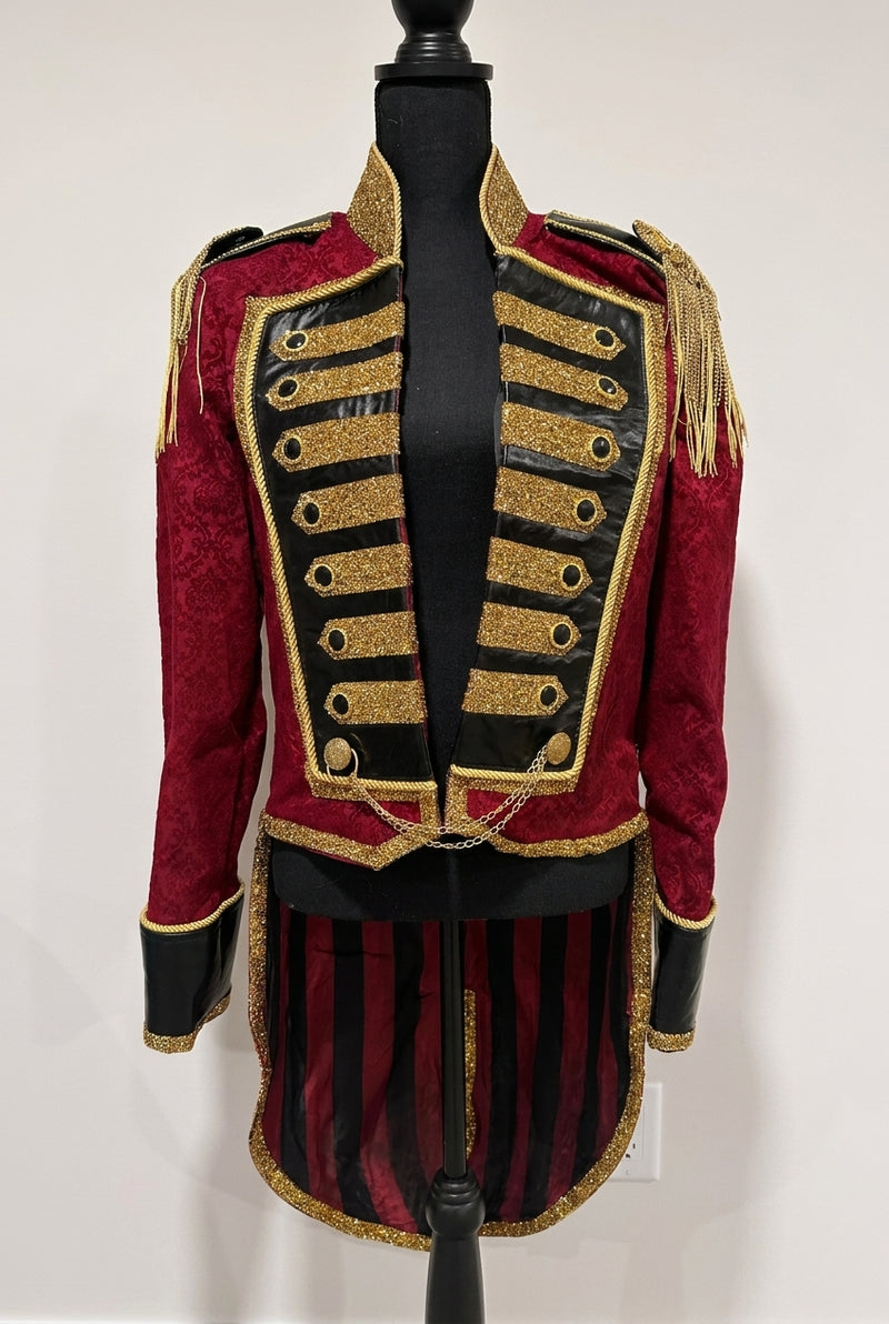 The Sovereign: An elite men's ringmaster tailcoat featuring a structured silhouette, heavy gold metallic embroidery on black contrast panels, and signature waist chains. A premium, hand-crafted statement piece for professional stage presence.